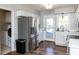 The eat-in kitchen features a stainless steel refrigerator and access to the laundry room at 4908 Birkenhead Ct, Apex, NC 27539