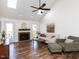 Bright living room with brick fireplace, skylights, hardwood floors, and cozy seating at 4908 Birkenhead Ct, Apex, NC 27539