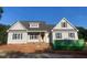 Charming single-Gathering home with gray siding, black shutters and a nicely framed front door at 499 Mulberry Rd, Spring Hope, NC 27882