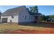 New home exterior with gray siding, rear deck and an unfinished lawn space at 499 Mulberry Rd, Spring Hope, NC 27882