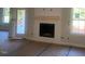 Bright living room showcasing a cozy fireplace, complemented by windows, and awaiting your personal touch at 499 Mulberry Rd, Spring Hope, NC 27882