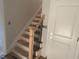 An unfinished staircase with wooden railings with black iron balusters leading to the upper level at 499 Mulberry Rd, Spring Hope, NC 27882