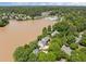 An aerial view of a lakeside home with lush landscaping near a community center at 5 Bobby Parker Pl, Durham, NC 27703