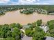 An aerial view of a lakeside home with lush landscaping in a neighborhood surrounded by a lake at 5 Bobby Parker Pl, Durham, NC 27703