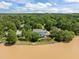 An aerial view of a lakefront home featuring lush landscaping, a private dock, and scenic water views at 5 Bobby Parker Pl, Durham, NC 27703