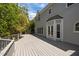 Inviting back deck with French doors and views of a well-maintained yard and trees at 5 Bobby Parker Pl, Durham, NC 27703