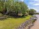 Spacious backyard featuring a private dock on the water, lush lawn, and landscaped garden beds at 5 Bobby Parker Pl, Durham, NC 27703