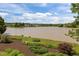 Tranquil view of backyard landscaping and lake, showcasing a serene and natural setting at 5 Bobby Parker Pl, Durham, NC 27703