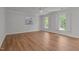 Bright bedroom with hardwood floors, neutral walls, and abundant natural light at 5 Bobby Parker Pl, Durham, NC 27703