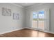 Serene bedroom featuring hardwood floors, neutral walls, and a picturesque view of the lake at 5 Bobby Parker Pl, Durham, NC 27703
