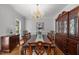 Formal dining room featuring a chandelier, large table, and custom china cabinet at 5 Bobby Parker Pl, Durham, NC 27703