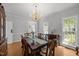 Elegant dining room with chandelier, large table, and natural light from windows at 5 Bobby Parker Pl, Durham, NC 27703