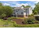Backyard home featuring a spacious lawn, mature landscaping, and a serene outdoor setting at 5 Bobby Parker Pl, Durham, NC 27703