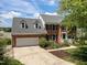 Charming two-story brick home with a two car garage, dormers, and professional landscaping at 5 Bobby Parker Pl, Durham, NC 27703