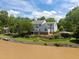 Lakeside home with a well-manicured lawn and mature trees creates a peaceful setting at 5 Bobby Parker Pl, Durham, NC 27703