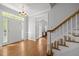 Inviting foyer with hardwood floors, chandelier, staircase and natural light at 5 Bobby Parker Pl, Durham, NC 27703