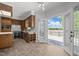 Kitchen with wood cabinets, tile floors and a door to a waterfront deck at 5 Bobby Parker Pl, Durham, NC 27703