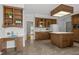 Spacious kitchen with wood cabinetry, a center island, and a cozy breakfast nook area at 5 Bobby Parker Pl, Durham, NC 27703