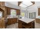 Spacious kitchen with wood cabinets, a central island, stainless steel appliances, and ample natural light at 5 Bobby Parker Pl, Durham, NC 27703