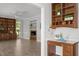 Bright living room featuring a built-in bookcase, neutral walls, and a glimpse of the cozy fireplace at 5 Bobby Parker Pl, Durham, NC 27703