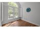 Window nook in a light-filled room with hardwood flooring and white trim at 5 Bobby Parker Pl, Durham, NC 27703