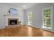 Bright living room featuring a fireplace, hardwood floors and natural light at 5 Bobby Parker Pl, Durham, NC 27703