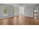 Bright living room with hardwood floors, lots of light, white trim and a view of the staircase at 5 Bobby Parker Pl, Durham, NC 27703