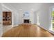 Spacious living room with a brick fireplace and hardwood flooring at 5 Bobby Parker Pl, Durham, NC 27703
