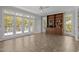 Bright sunroom with large windows, tile floors, and built in bookcase at 5 Bobby Parker Pl, Durham, NC 27703