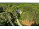 An aerial view showcases a home nestled in a forest of lush, mature trees at 503 Belmont Cir, Wake Forest, NC 27587
