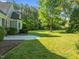 Lush backyard featuring a concrete patio and mature trees providing shade and privacy at 503 Belmont Cir, Wake Forest, NC 27587