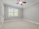 Light-filled bedroom with neutral carpet, ceiling fan, and window at 503 Belmont Cir, Wake Forest, NC 27587