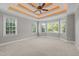 A spacious bedroom with carpet, tray ceiling and several large windows providing ample natural light at 503 Belmont Cir, Wake Forest, NC 27587