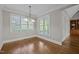 Bright dining room with hardwood floors, large windows, and a pendant light fixture at 503 Belmont Cir, Wake Forest, NC 27587