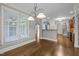 Bright dining room with hardwood floors, large windows, and elegant chandelier at 503 Belmont Cir, Wake Forest, NC 27587