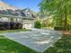 Long driveway leading to a two-car garage, complemented by mature trees and manicured landscaping at 503 Belmont Cir, Wake Forest, NC 27587