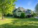 Charming exterior view of a well-maintained home with lush landscaping and a spacious, green lawn at 503 Belmont Cir, Wake Forest, NC 27587
