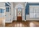 Inviting foyer with dark wood floors, an arched window over the front door, and blue accent walls at 503 Belmont Cir, Wake Forest, NC 27587