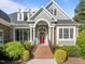 Close-up of a beautiful home featuring a red front door and well-manicured landscaping, creating a welcoming entrance at 503 Belmont Cir, Wake Forest, NC 27587