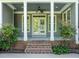 Charming front porch featuring white columns, double doors, and well-maintained landscaping at 503 Belmont Cir, Wake Forest, NC 27587