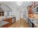 Open kitchen with wood cabinets, stainless appliances, granite counters, and hardwood floors at 503 Belmont Cir, Wake Forest, NC 27587