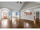 Open-concept living room with hardwood floors, elegant archways, and a seamless flow to the dining area and kitchen at 503 Belmont Cir, Wake Forest, NC 27587