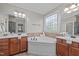 Main bathroom with dual sinks, vanity, and tub beneath a decorative window at 503 Belmont Cir, Wake Forest, NC 27587