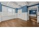 Blue accent room with hardwood floors, a coffered ceiling, wainscoting, and natural light at 503 Belmont Cir, Wake Forest, NC 27587