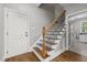 Wooden staircase with iron spindles, offering a blend of elegance and safety at 503 Belmont Cir, Wake Forest, NC 27587