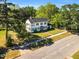 A picturesque aerial shot captures a classic two-story home nestled among mature trees and a well-manicured lawn at 506 S King Ave, Dunn, NC 28334