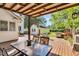 Covered patio with an outdoor dining set, grilling area and a shed in the backyard at 506 S King Ave, Dunn, NC 28334