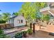 Charming backyard with brick patio, wooden deck, privacy fence and a unique building at 506 S King Ave, Dunn, NC 28334