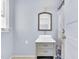 Bright bathroom featuring a vanity with sink and a shower with nautical-themed curtain at 506 S King Ave, Dunn, NC 28334