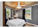 Cozy bedroom with a ceiling fan, wood floors and built-in shelving at 506 S King Ave, Dunn, NC 28334